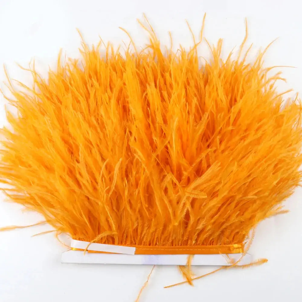 Bright orange premium feather fringe with soft fluffy ostrich trim and neatly bound base for diy fashion projects