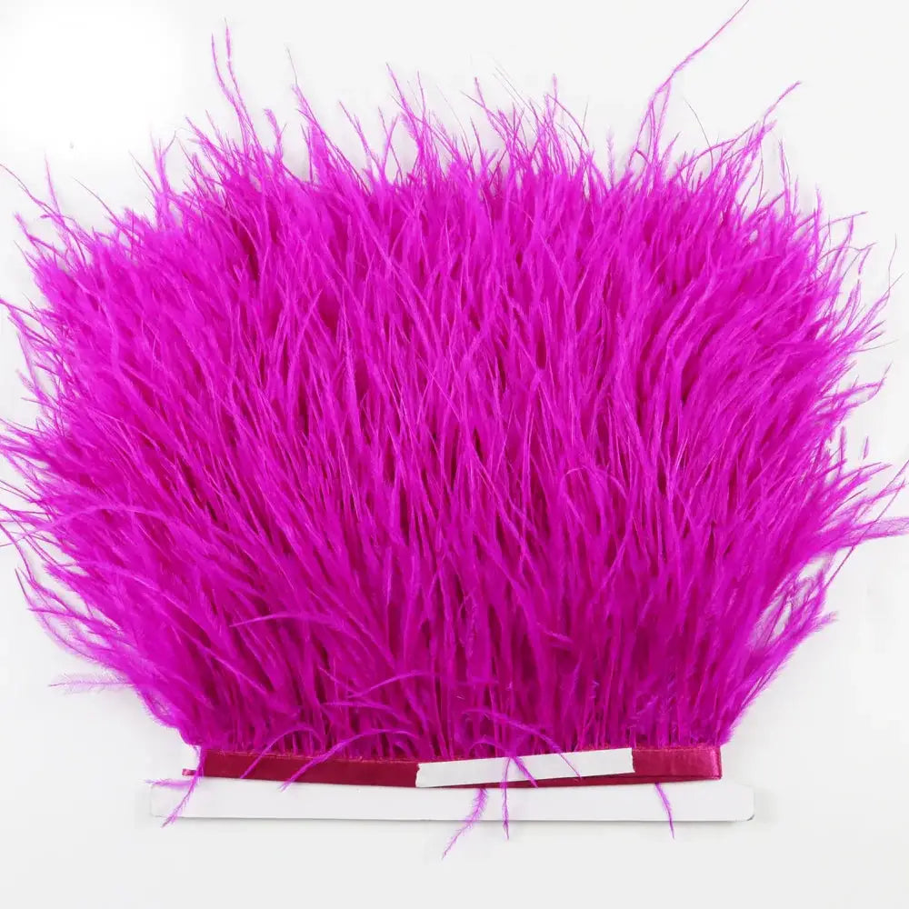 Premium feather fringe and ostrich trim featuring vibrant fuchsia soft fluffy feathers with a neatly bound base for diy fashion