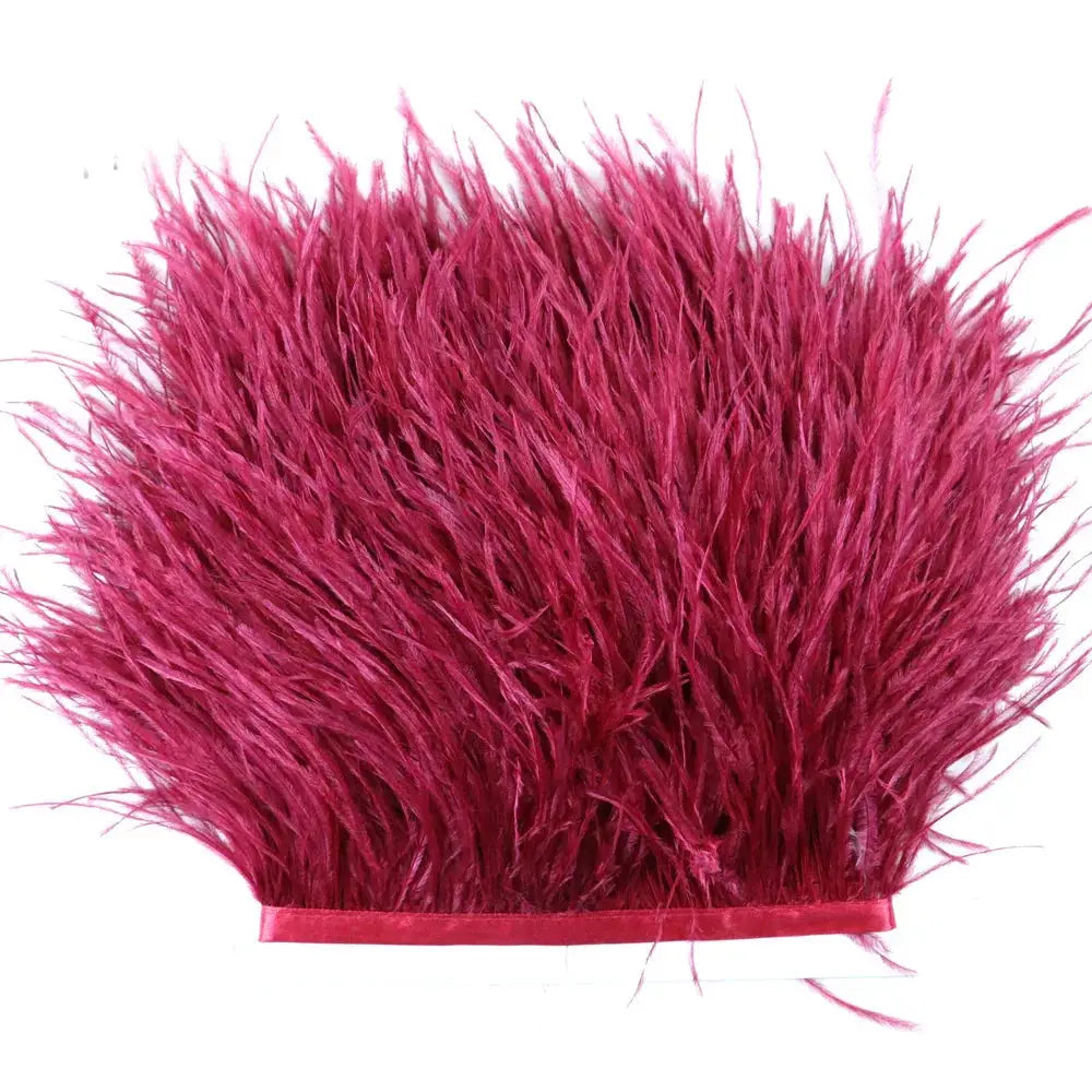 Premium feather fringe and ostrich trim in vibrant fuchsia with dense fluffy feathers and a satin ribbon base for diy fashion