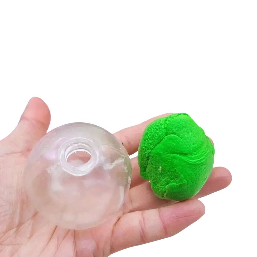A translucent plastic mold with a central hole beside vibrant green kinetic sand for diy handmade sensory squishy ball