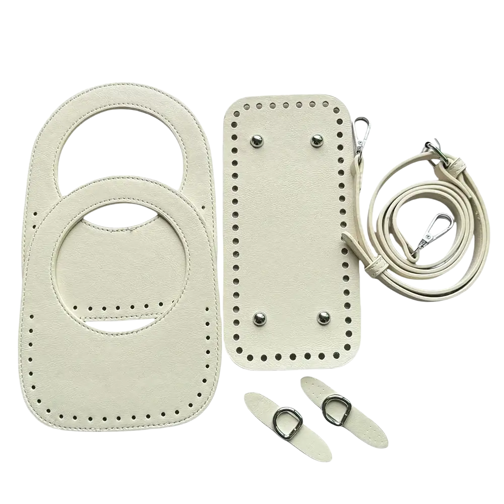 Cream-colored leather handbag making kit featuring circular handle and adjustable strap in an 8-piece set
