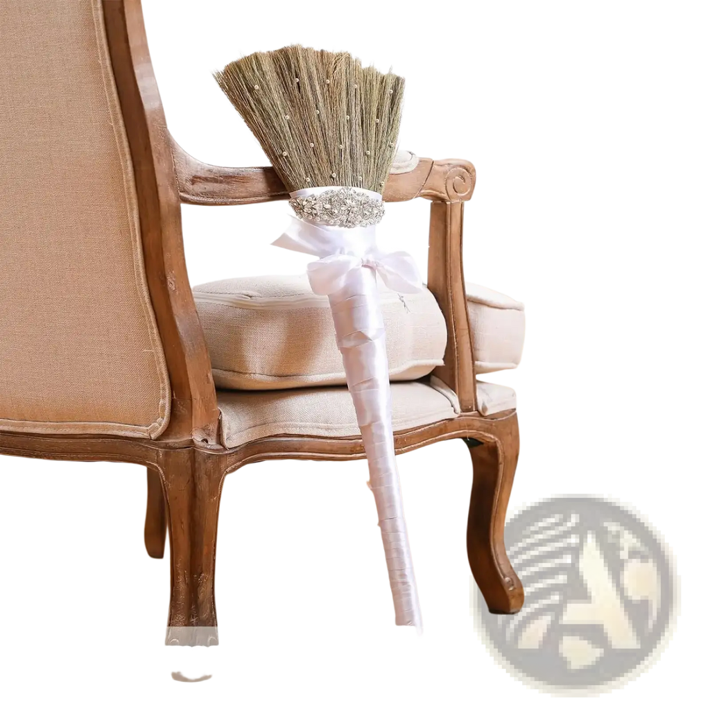 Diy wedding jumping broom with white satin handle and sparkling silver embellishment at base of straw bristles