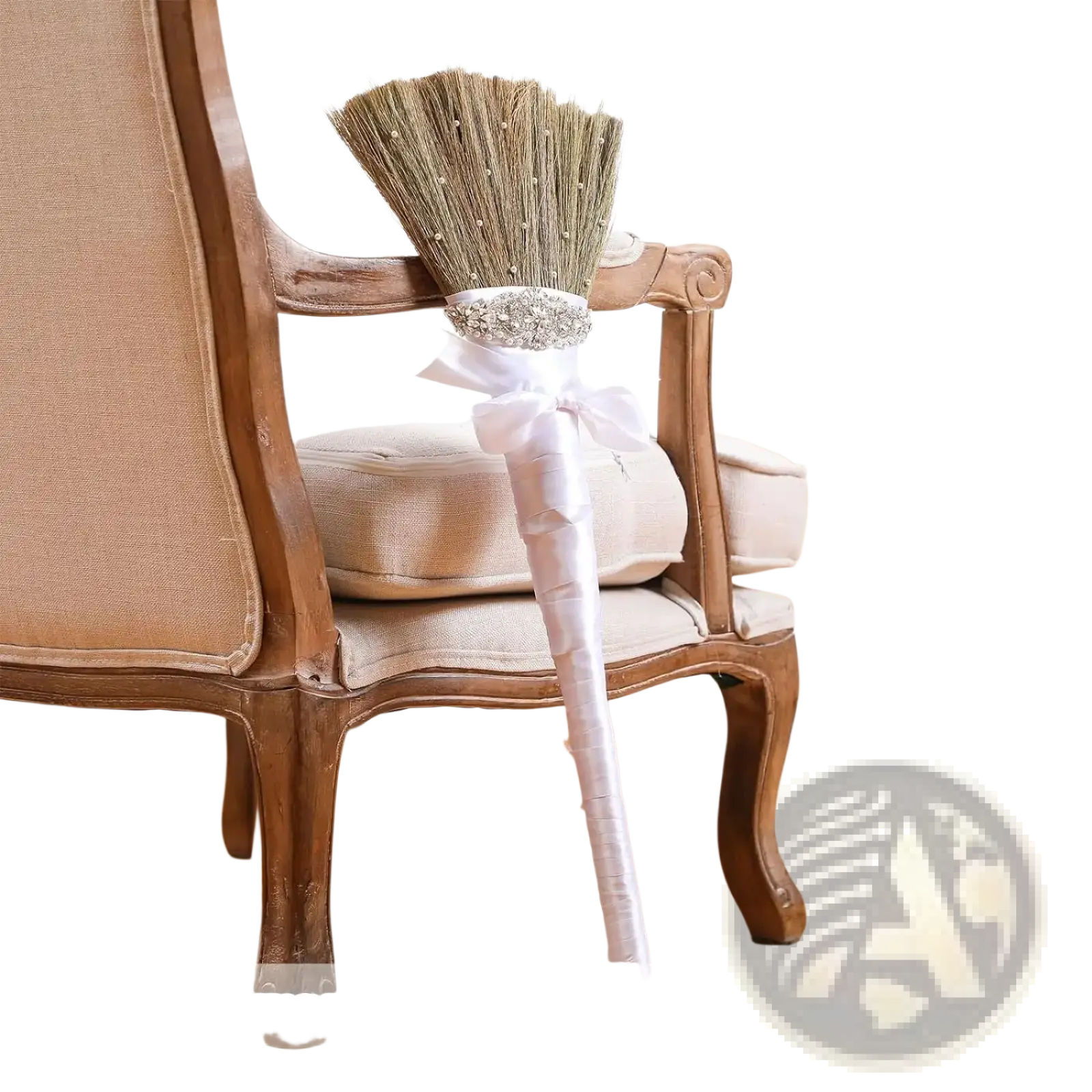 Diy wedding jumping broom with white satin handle and sparkling silver embellishment at base of straw bristles