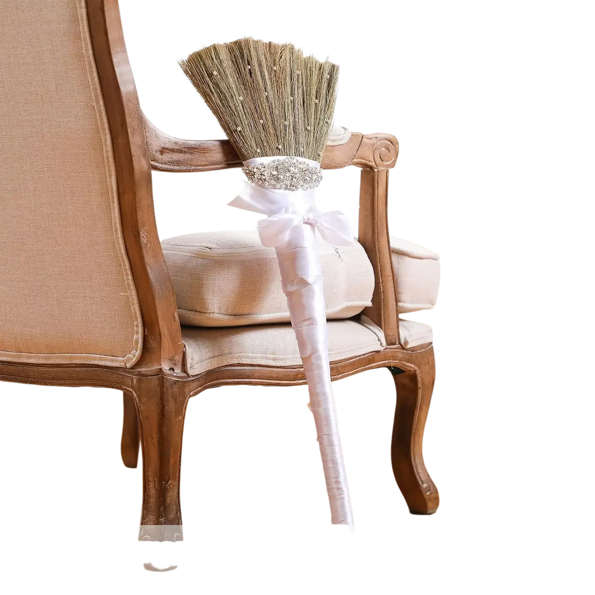 Diy wedding jumping broom with white satin handle and sparkling silver embellishment at base of straw bristles