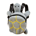 Gray plush dog backpack shaped like a turtle with yellow embroidered shell patterns and black straps