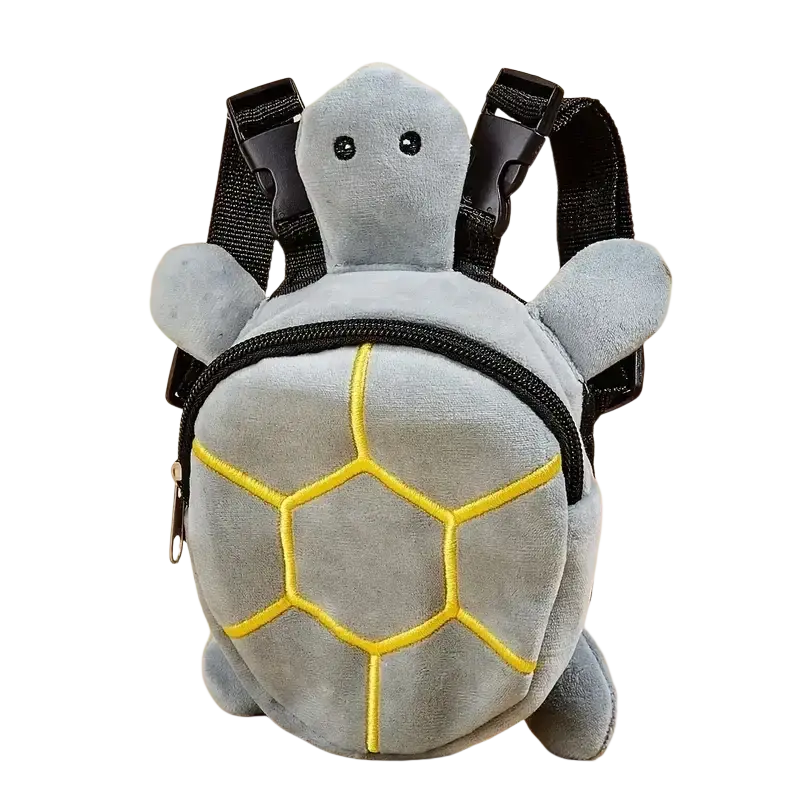 Gray plush dog backpack shaped like a turtle with yellow embroidered shell patterns and black straps