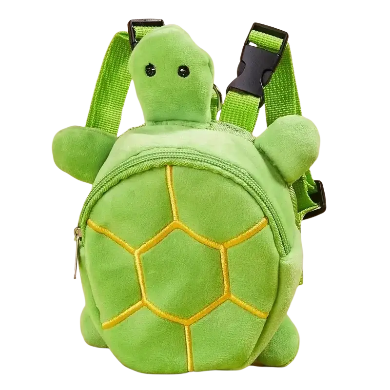 Plush green turtle-shaped dog backpack with yellow embroidered shell patterns and adjustable straps for pet carrying