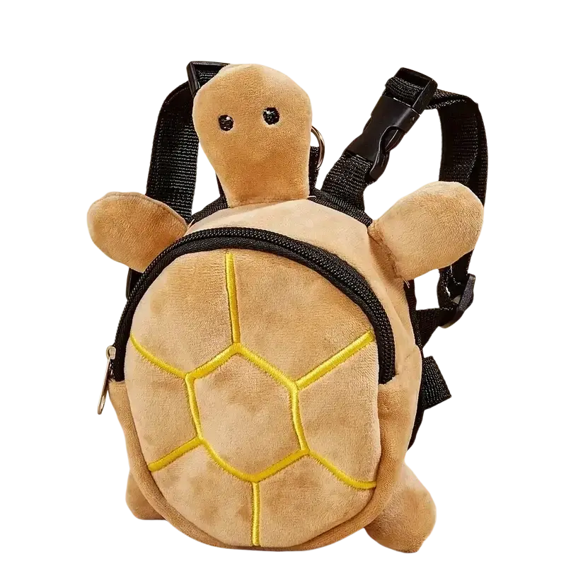 A plush tan dog backpack shaped like a turtle with yellow embroidered shell patterns and black straps for carrying pets