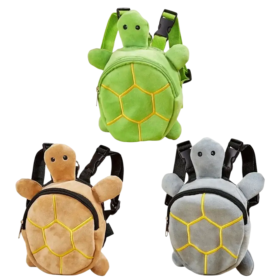 Three plush turtle-shaped dog backpacks in green tan and gray with yellow stitching on their shells for pet carrying