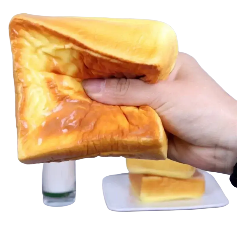 Golden-brown fluffy dog bread slow rising squishy toy with soft airy texture and slightly glossy surface