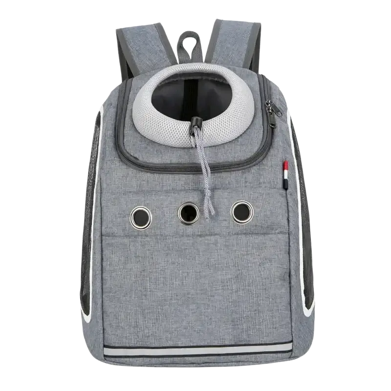 Gray textured dog carrier bag with circular mesh opening, black zippers, white piping, and three ventilation holes