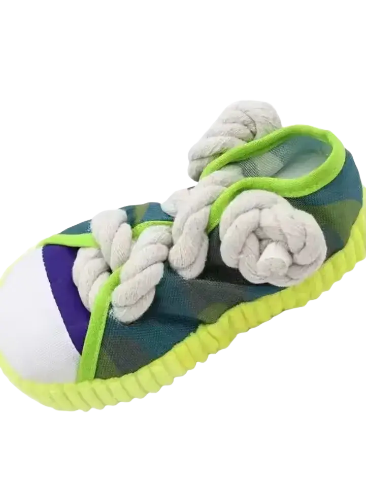 A plush dog toy in green and purple plaid with white rope laces and neon yellow sole for chew toys use