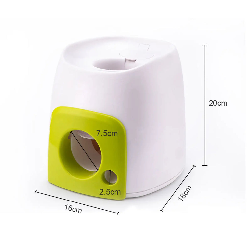 White and lime green plastic dog food reward machine interactive ball launcher toy with circular opening and square cutout panel