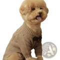A fluffy tan poodle wearing a beige knitted dog sweater with a black bow tie for pet winter apparel