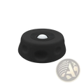Black rubber grip cap with textured surface and central recess holding white golf ball for dog lick bowl slow feeder