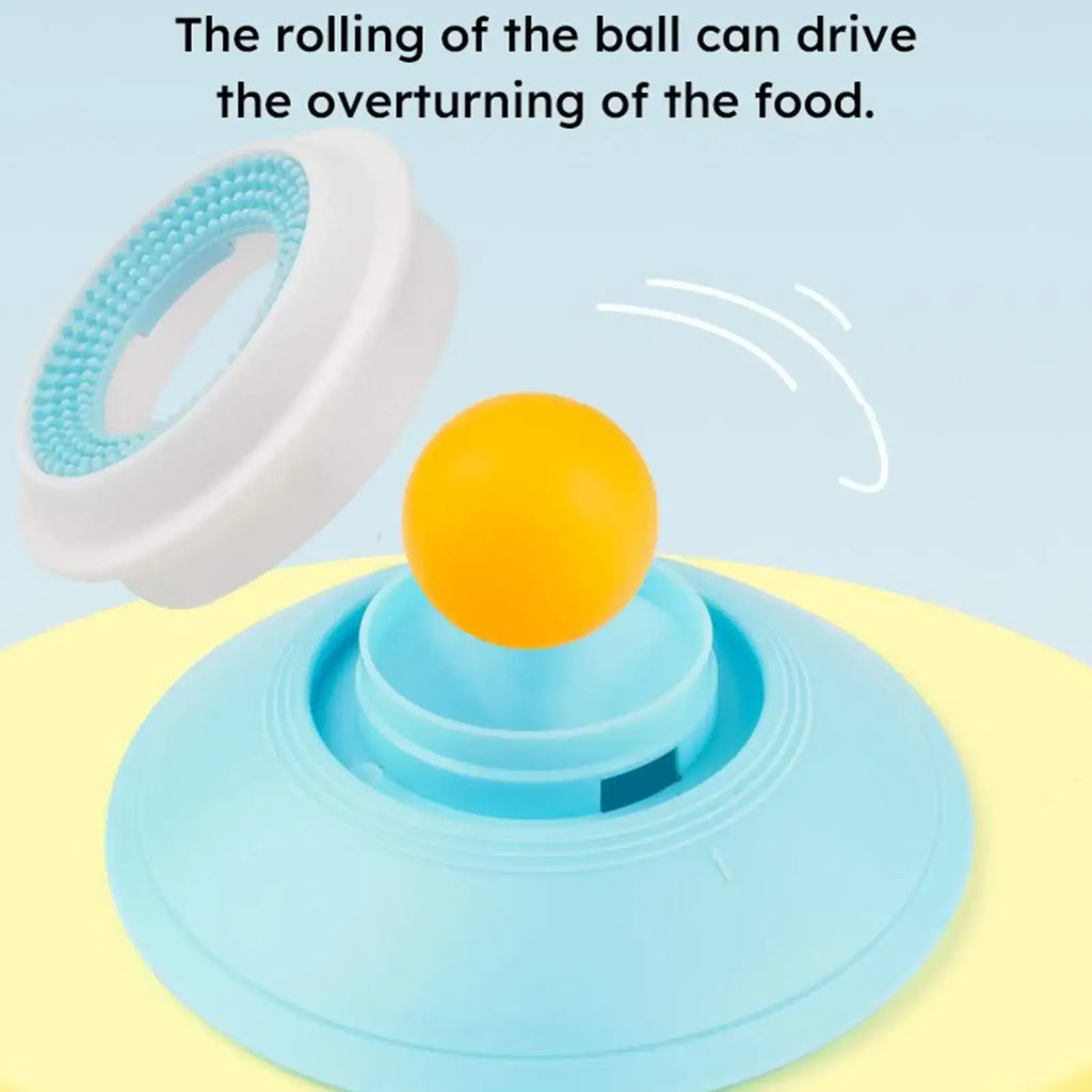 A bright orange spherical dog lick toy on a light blue plastic base with concentric rings for slow feeding