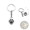 Silver dog paw urn keychain with black enamel inlay made of metal for cremation memorial pendant use