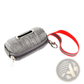 Gray textured fabric dog poop bag dispenser with silver zipper and red reflective strap for nighttime use