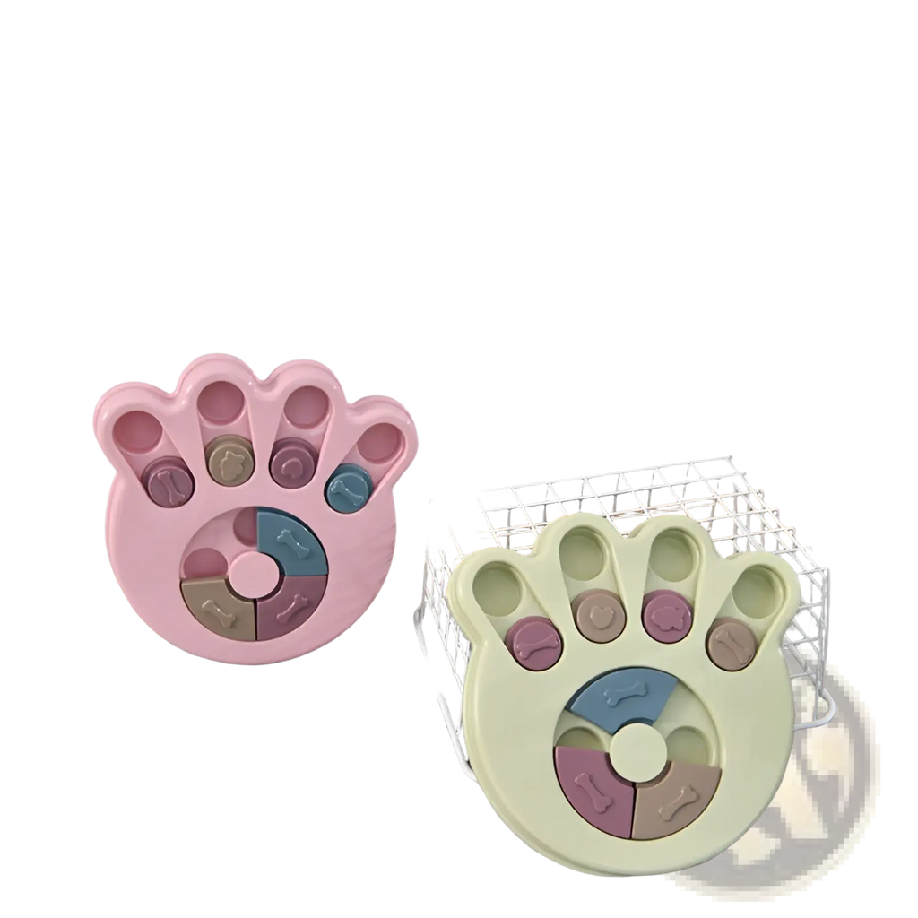 Pink and pale green paw-shaped interactive dog puzzle toy with colorful bone-embossed treat compartments for training