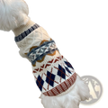 A cozy cream-colored knitted dog sweater with vintage geometric patterns in navy blue rust red and gray