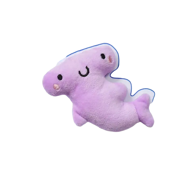 A soft lavender plush hammerhead shark dog toys pet with embroidered eyes and smiling mouth for interactive play