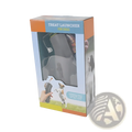 Gray plastic dog training snack launcher packaged in colorful orange and blue cardboard box for pet treat shooting