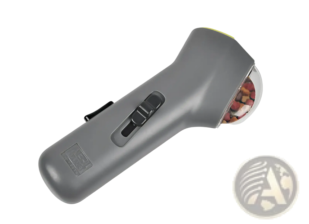 Gray handheld pill organizer with transparent compartment and black sliding mechanism for dog training snack launcher