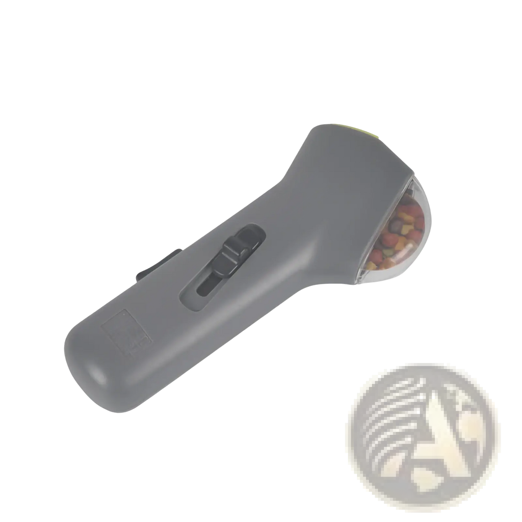 Gray plastic dog training snack launcher with clear rounded compartment filled with colorful kibble for pet treats