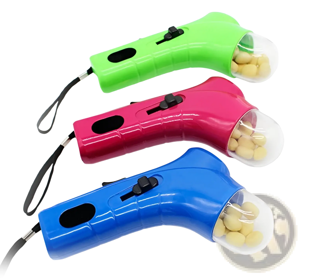Three brightly colored plastic dog treat launcher handheld pet snack feeder toys with transparent compartments filled with yellow treats