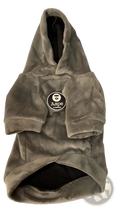 A soft olive-green velour dog winter hoodie with a fluffy gray pom-pom and Aape logo patch on the hood