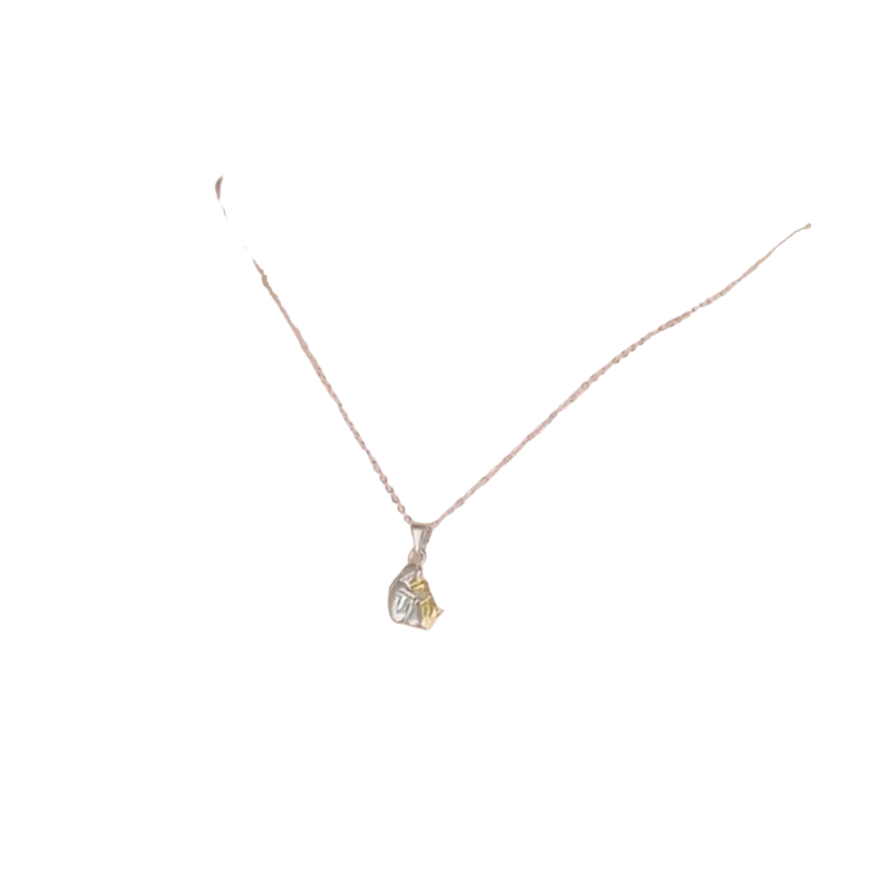 A delicate silver dog and woman hug pendant necklace with a two toned alloy design and yellow gemstone accent