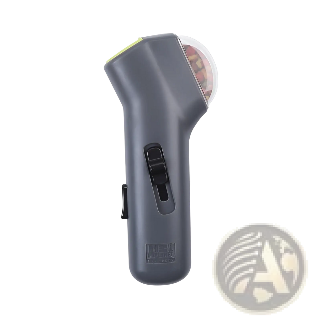 Gray plastic doggie treat launcher remote pet toy with transparent dome showing colorful seeds and black side switch