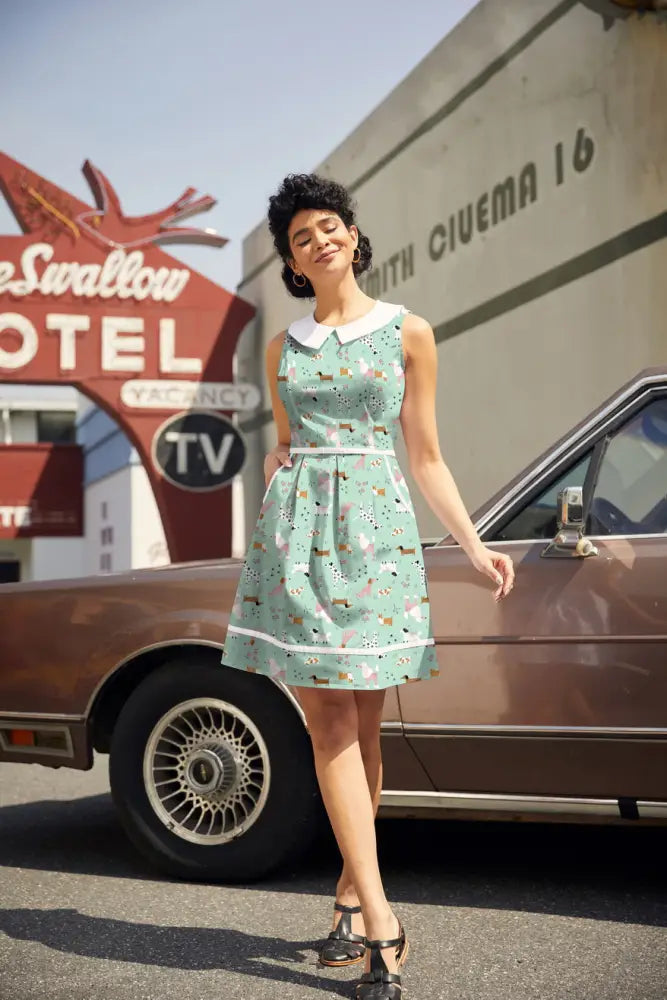 Mint sleeveless cotton a-line dress with white peter pan collar dachshund print and white trim at waist and hem with pockets