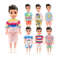 A collection of seven boy dolls with black hair and large eyes wearing a 6 piece colorful doll clothes set