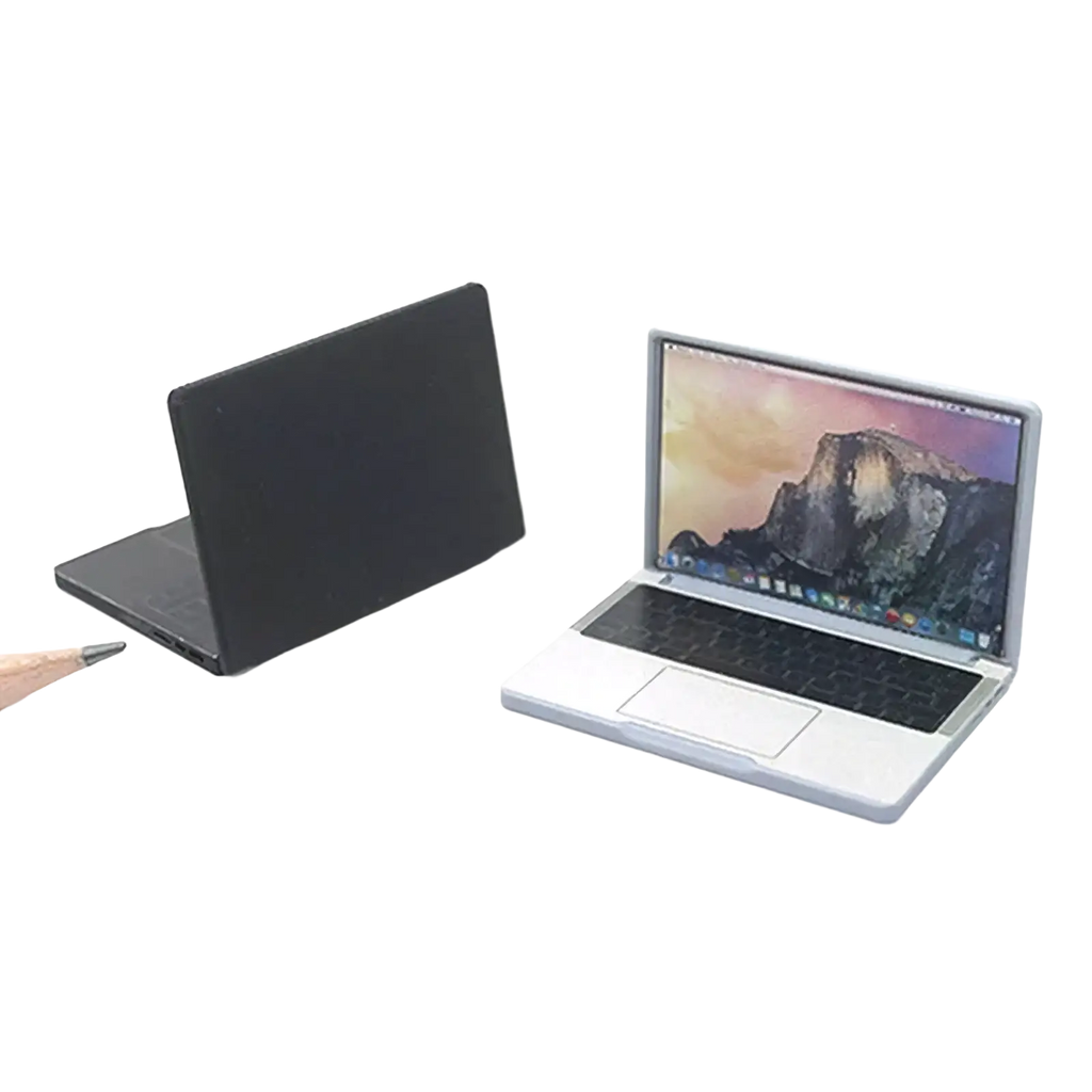 Silver dollhouse miniature laptop 1/12 scale with black keyboard and trackpad showing mountain landscape wallpaper