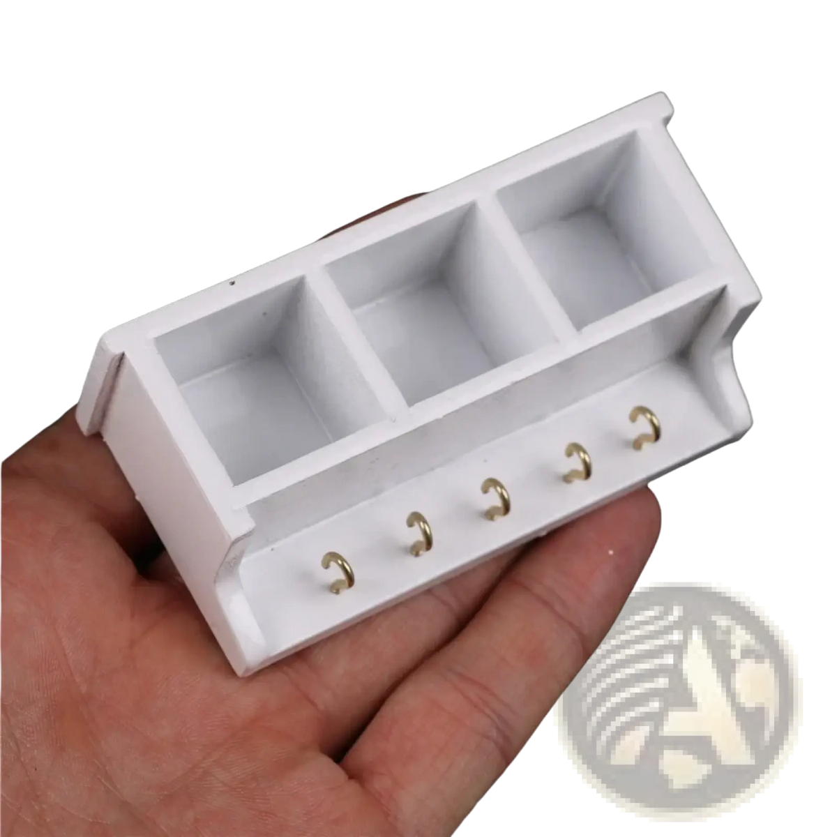 Dollhouse miniature white wall rack with three square compartments and five gold-colored hooks for organizing small items