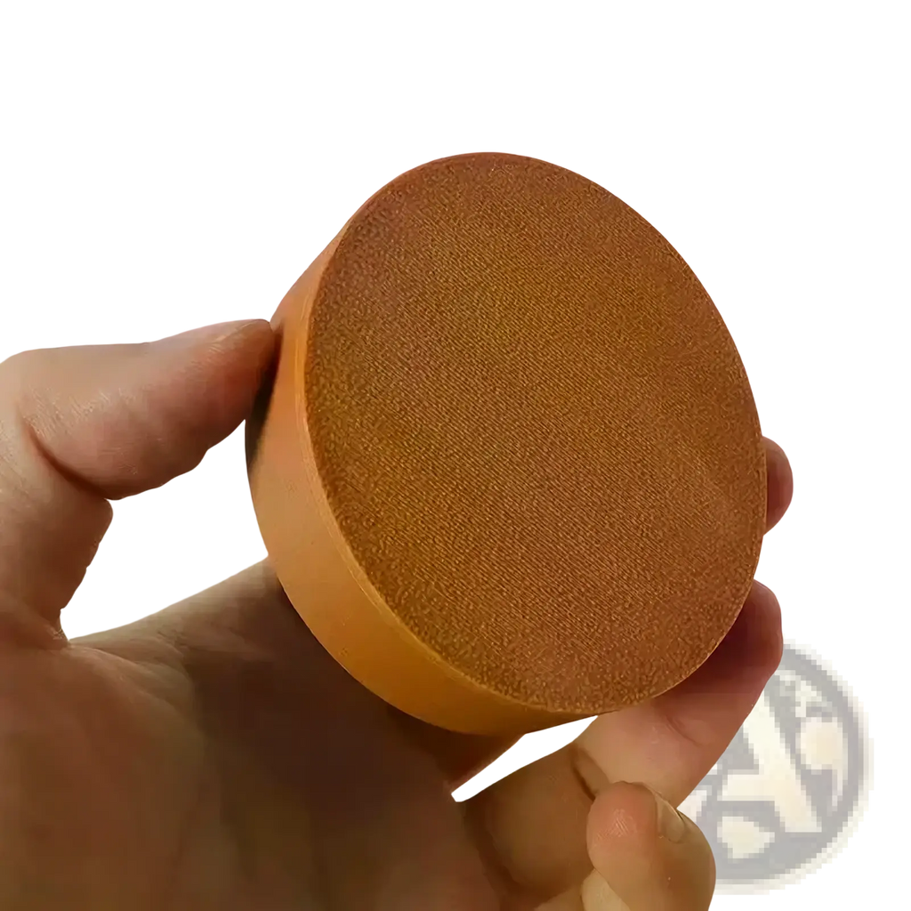 A round orange sponge with a textured surface for use in a dollhouse wall cabinet miniature wooden display shelf