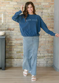 Blue mom club sweatshirt with long sleeves and relaxed fit paired with donna classic wash stretch denim maxi skirt with pockets
