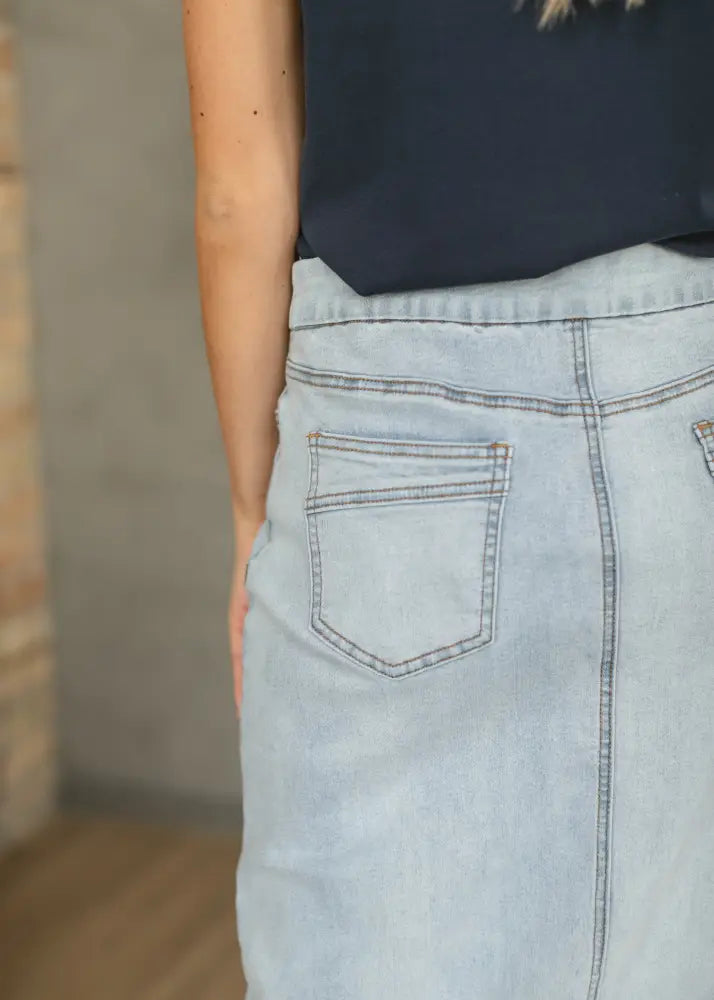 Back side of donna light wash stretch denim maxi skirt showing classic pocket design and visible stitching details