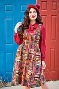 A vibrant bookshelf print cotton fit and flare dress with long sleeves, red bow collar, and pockets