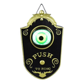Black and gold ornate doorbell haunted with a glowing green eye horror prop made in mainland china for spooky decor