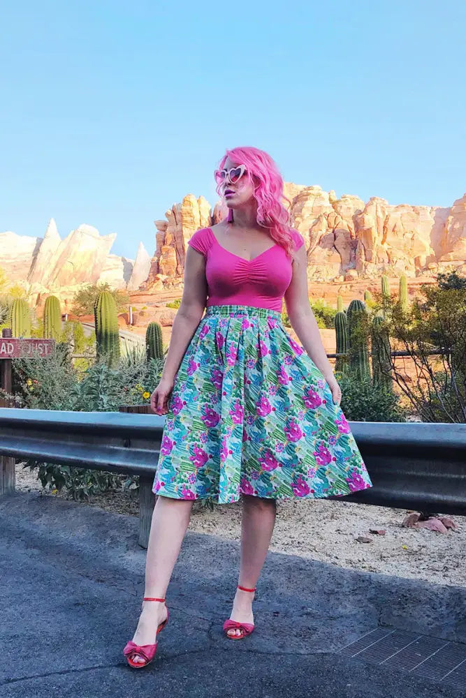Doris cactus floral a-line midi skirt with pockets featuring a vibrant pink and teal floral print and fitted waistband