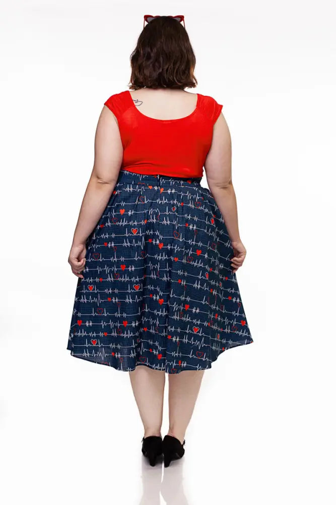 Doris navy pleated heartbreaker skirt in navy blue with red hearts and white electrocardiogram lines with pockets