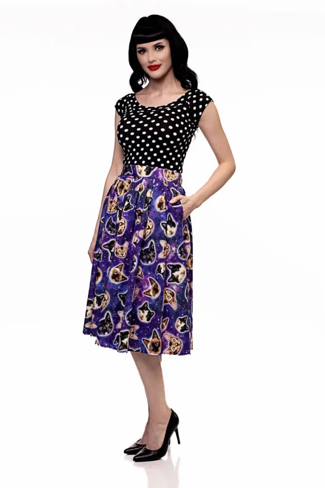 A black and white polka dot top paired with a space cats galaxy print vintage purple a line skirt