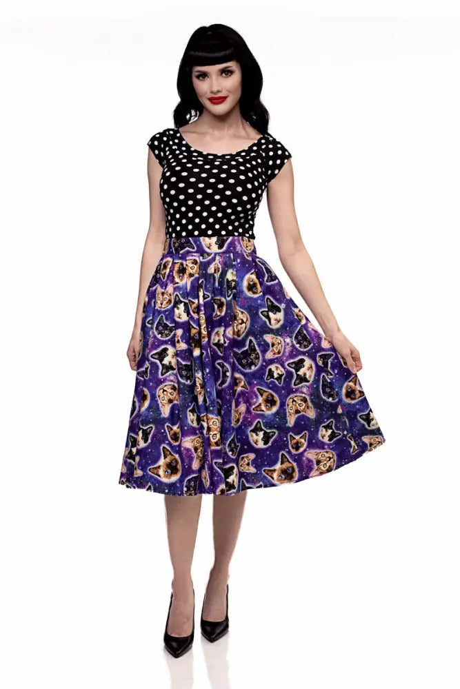A vintage-style purple flared a line skirt with a cosmic print featuring cat faces and stars