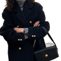 Black double breasted wool coat for women with gold toned buttons and structured silhouette for winter wear