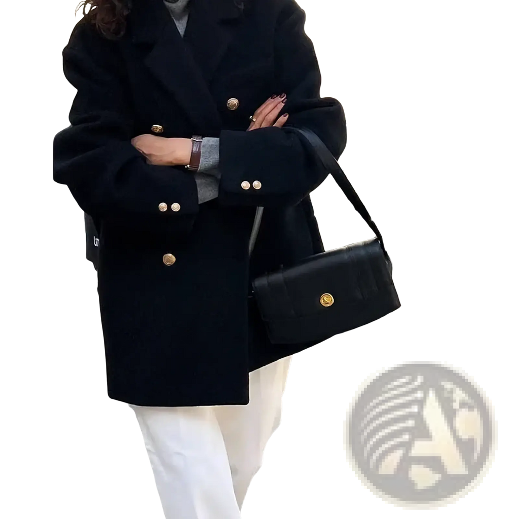Black leather crossbody bag with gold tone hardware complements double breasted wool coat for winter wear