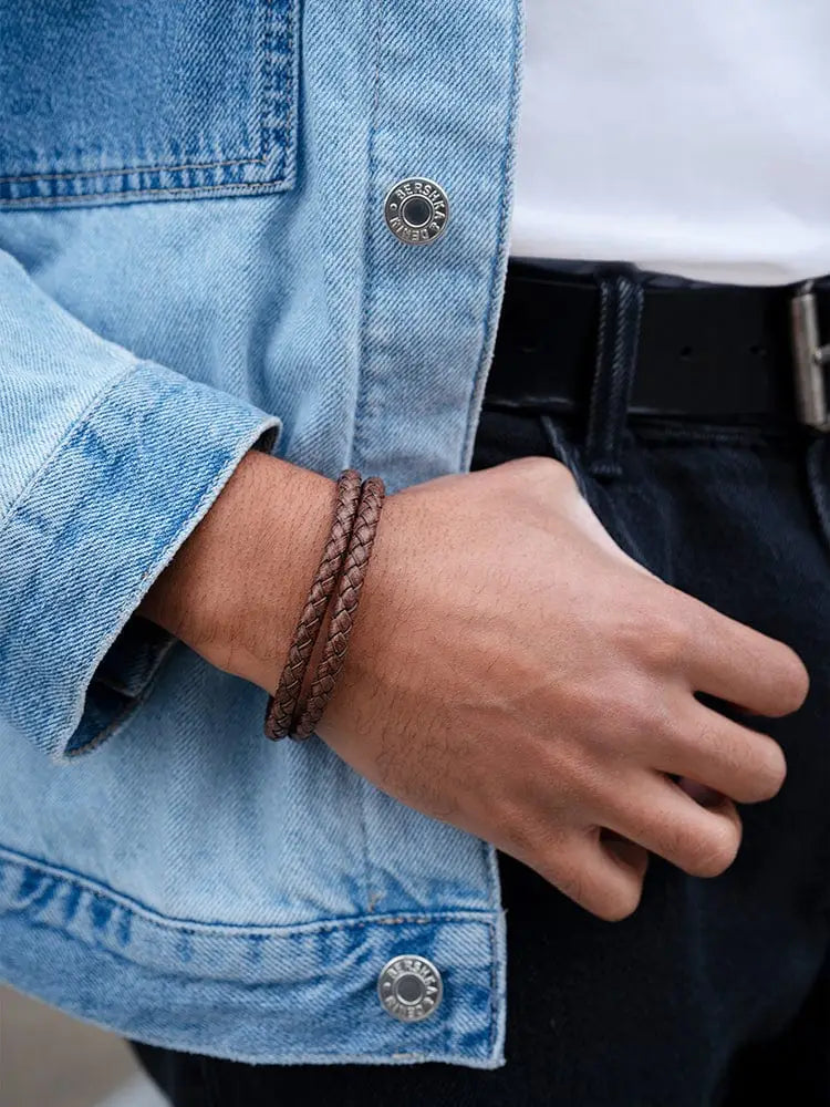 Double brown braided leather bracelet with stainless clasp worn on wrist showcasing its braided design and clasp functionality