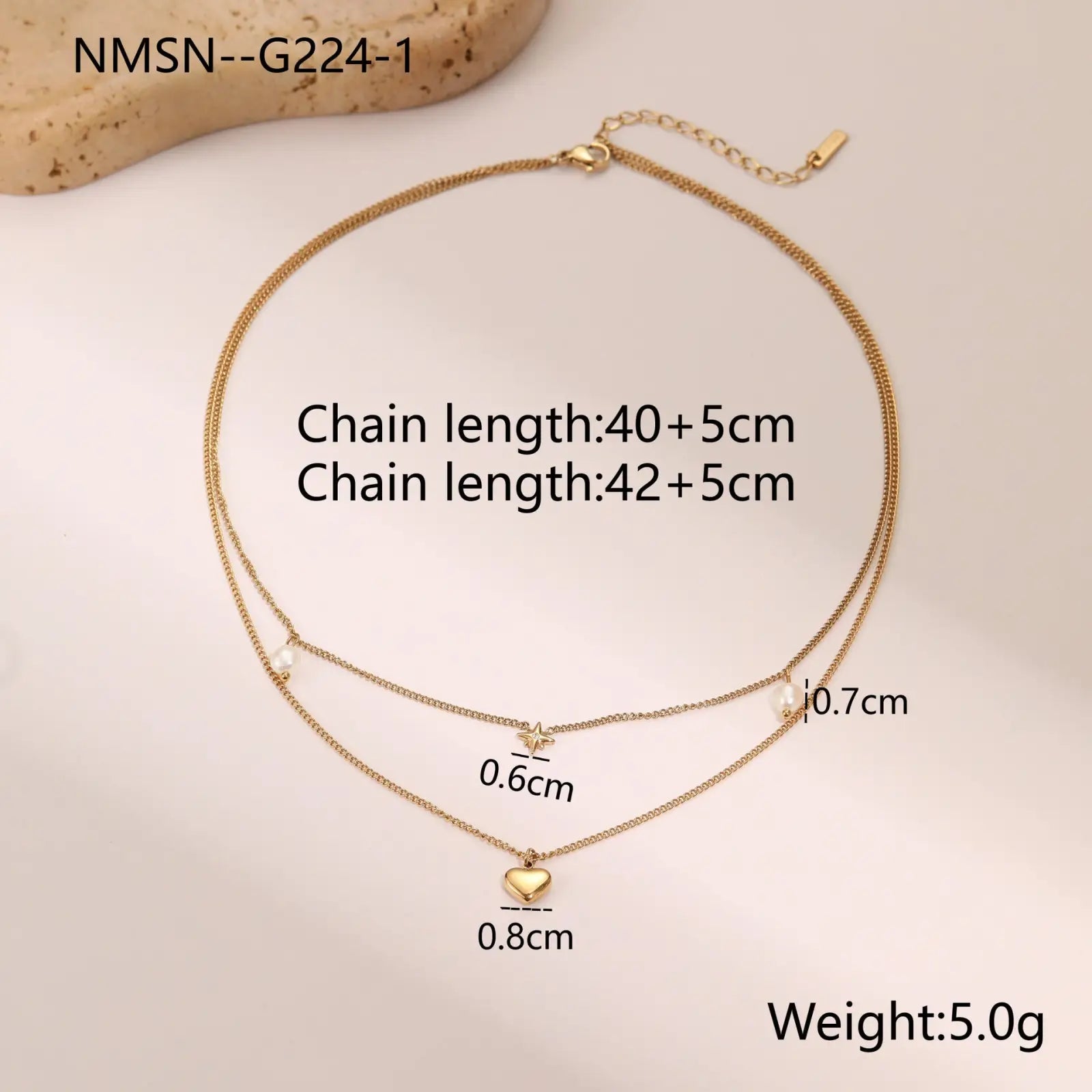 Double layer 18k gold stainless steel necklace with star and pearl accents featuring a delicate heart pendant