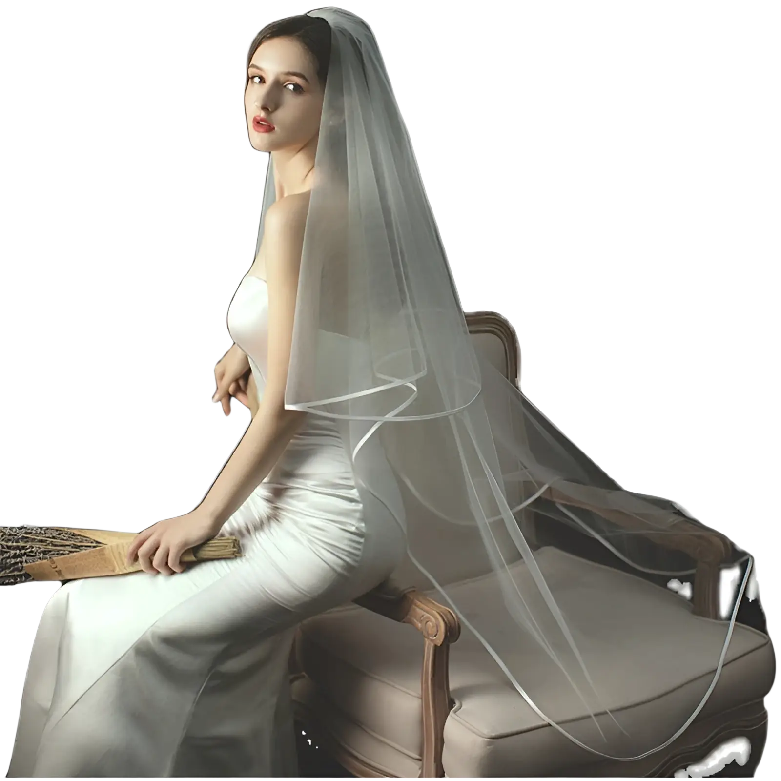 A delicate double layer white tulle short veil with hair comb drapes softly over the model’s head and shoulders